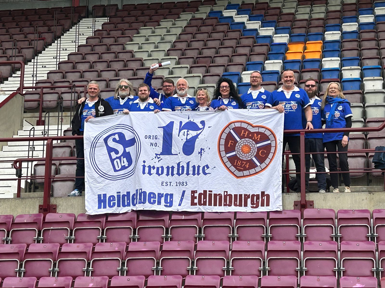 Fanclub-Gruppe mit Jubiläumsfahne auf der Tribüne bei Hearts of Midlothian
